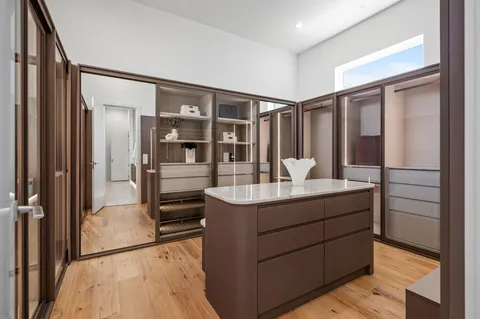 a bathroom with a granite countertop sink mirror and shower