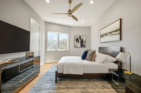 a bedroom with a bed and a flat screen tv