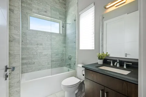 a bathroom with a sink a toilet and a bathtub