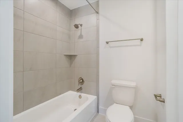 a bathroom with a toilet and a bathtub