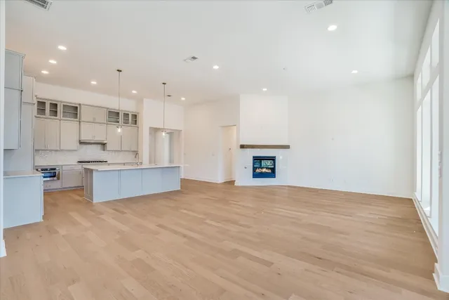 a large kitchen with a sink and a large window