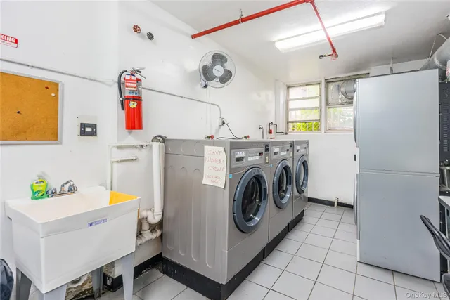 a utility room with cabinets washer and dryer