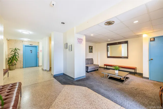 a living room with furniture gym equipment and a window