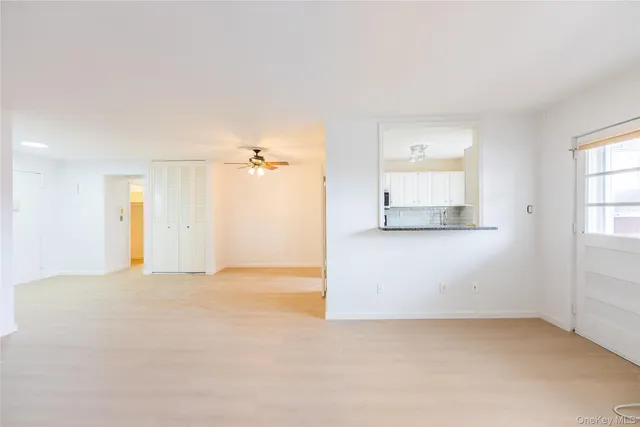 an empty room with windows and closet