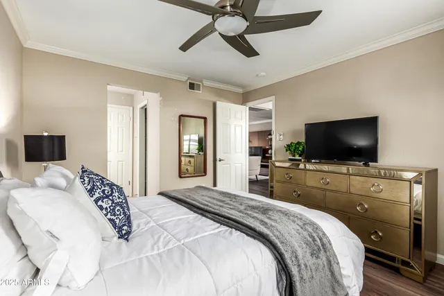 a bedroom with a bed and a flat screen tv