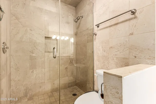 a bathroom with a shower and toilet