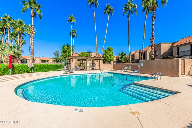 a view of a swimming pool with a lounge chairs