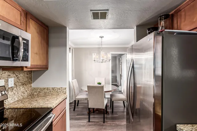 a kitchen with stainless steel appliances granite countertop a refrigerator and microwave
