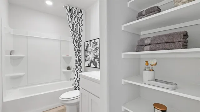 a bathroom with a toilet sink and shower