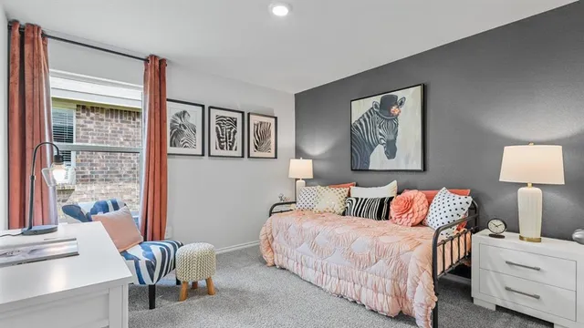 a bedroom with a bed and a couch next to a window