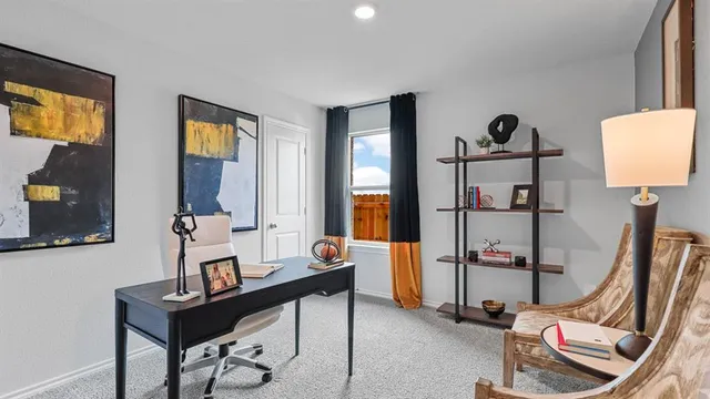 a view of a workspace with furniture and a window