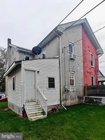 a view of entryway and gallery with wooden floor