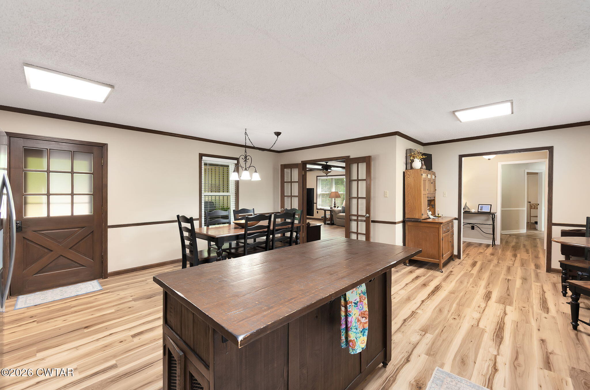 328 New Hope Road Ripley, TN 38063 - Photo 12 of 39 a kitchen with stainless steel appliances granite countertop a stove a refrigerator a dining table and chairs with wooden floor