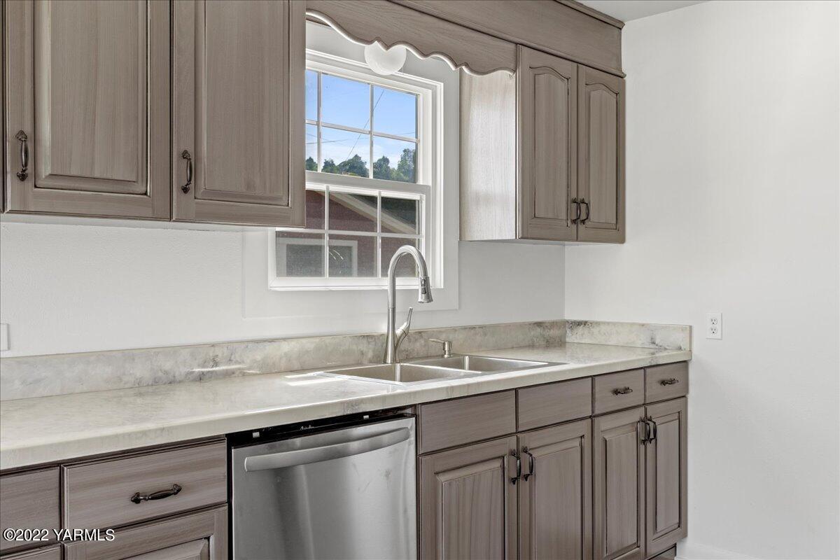 a sink with white cabinets