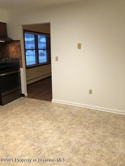 1115 Wheeler Avenue, Unit 1L Dunmore, PA 18510 - Photo 4 of 13 a view of an empty room and kitchen