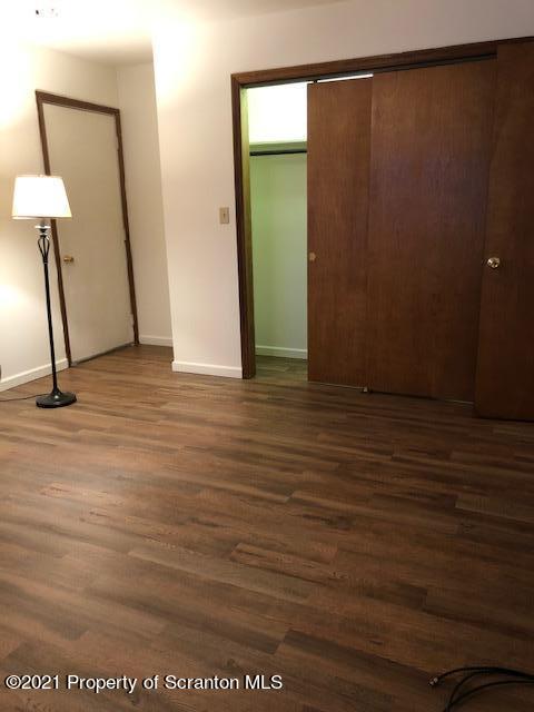 1115 Wheeler Avenue, Unit 1L Dunmore, PA 18510 - Photo 9 of 13 a view of a room with wooden floor and a chair