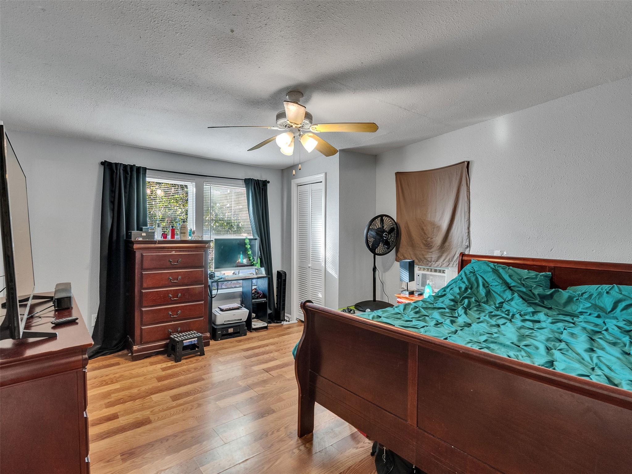 4323 Avenue R 1/2 Galveston, TX 77550 - Photo 12 of 41 Bedroom 1 (Front Unit):
The first bedroom features warm wood floors and a clean, airy feel. It’s a comfortable retreat with room for a full setup—ideal for relaxing after a day on the island