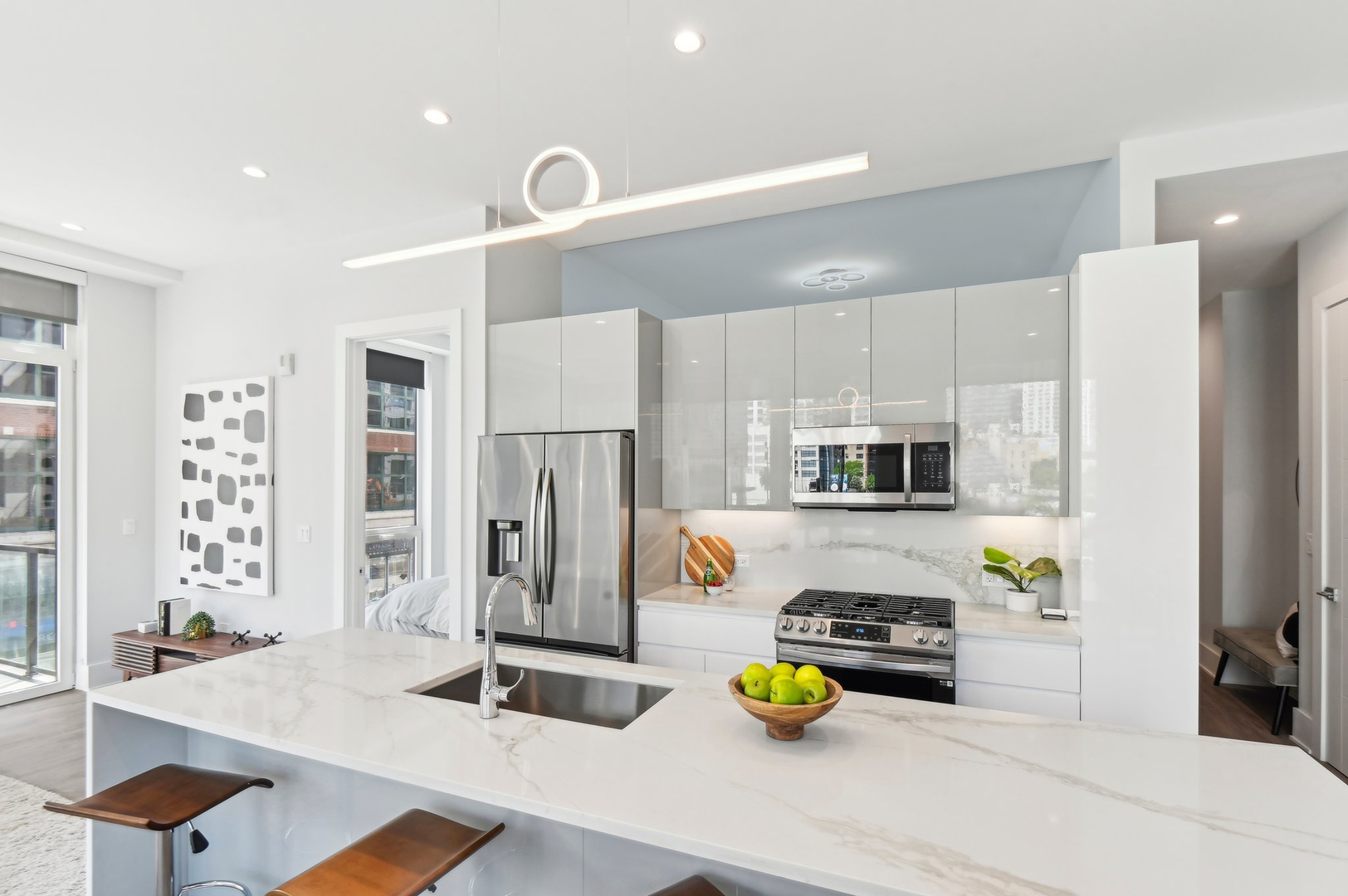 812 West Adams Street, Unit 600 Chicago, IL 60607 - Photo 13 of 46 a kitchen with stainless steel appliances kitchen island granite countertop a refrigerator and a stove