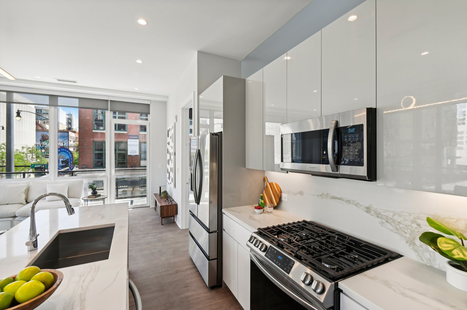 812 West Adams Street, Unit 600 Chicago, IL 60607 - Photo 17 of 46 a kitchen with stainless steel appliances granite countertop a stove a refrigerator a sink dishwasher and white cabinets with wooden floor
