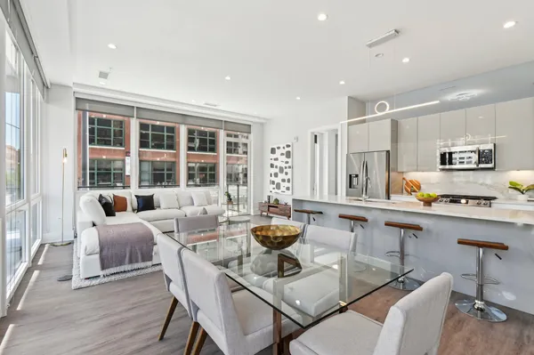 a kitchen with a dining table wooden floor and appliances
