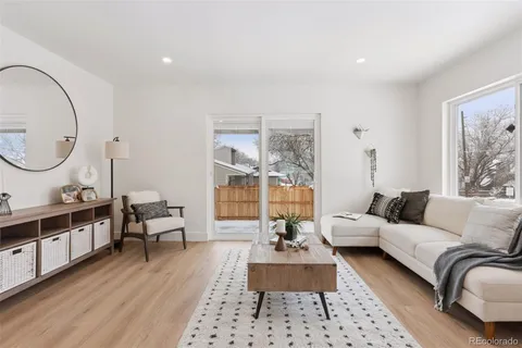 a living room with furniture a rug and a large window