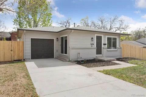 a view of a house with a yard and garage