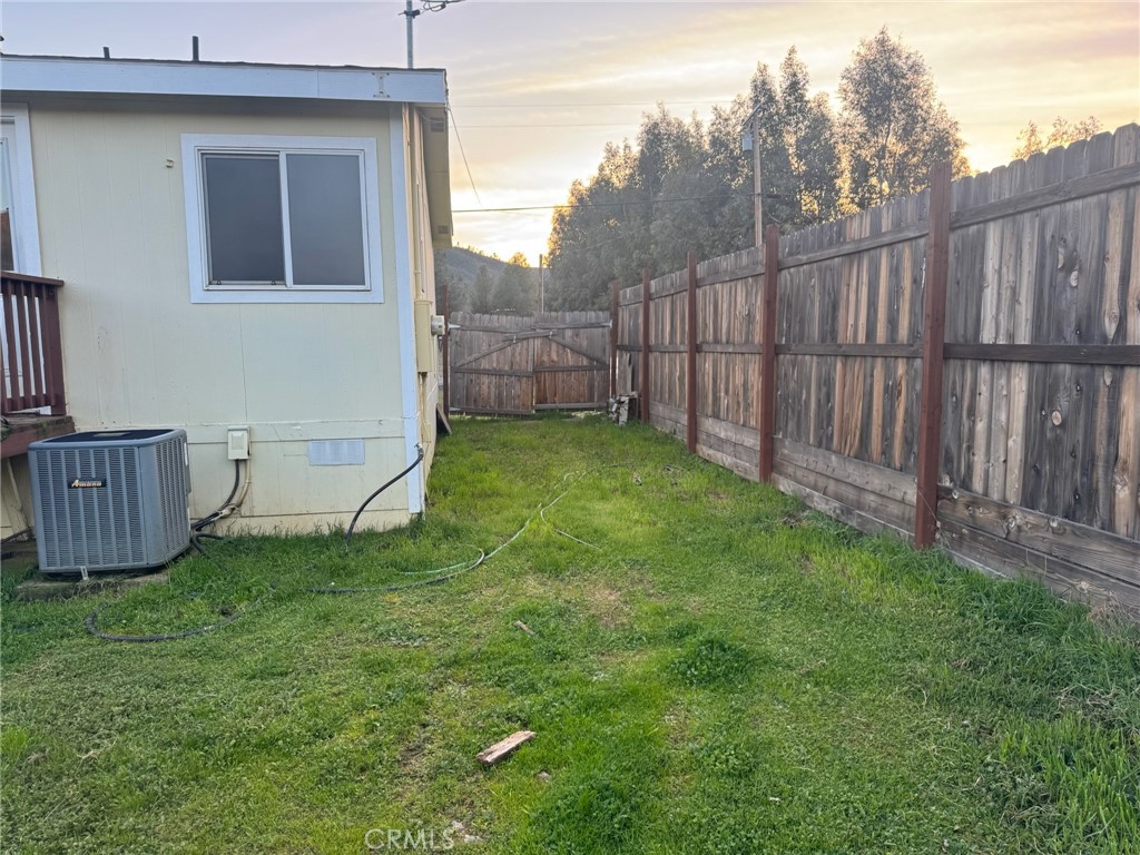 3096 Spring Valley Road Clearlake Oaks, CA 95423 - Photo 3 of 7 a view of a backyard with wooden fence