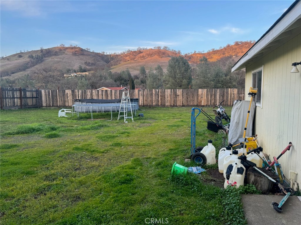 3096 Spring Valley Road Clearlake Oaks, CA 95423 - Photo 5 of 7 a view of a house with a yard and sitting area