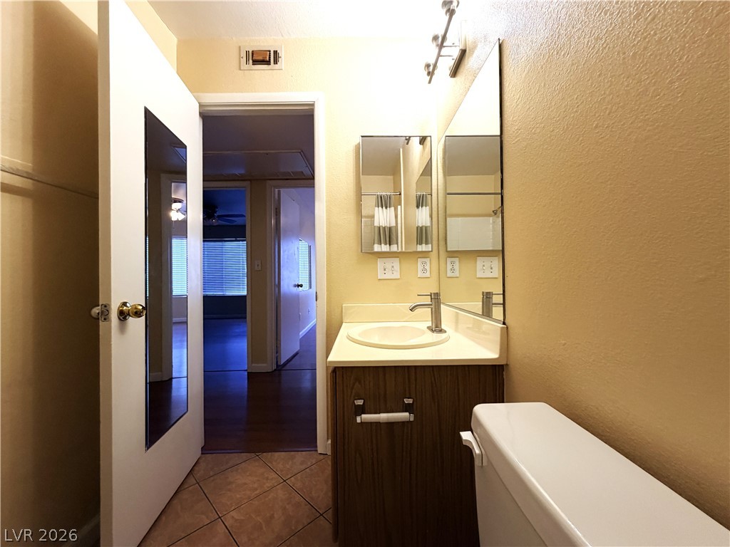 4955 South Lindell Road, Unit 203 Las Vegas, NV 89118 - Photo 22 of 31 A well-appointed bath features a single vanity and essential fixtures.