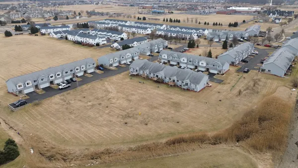 an aerial view of a house a yard and ocean view