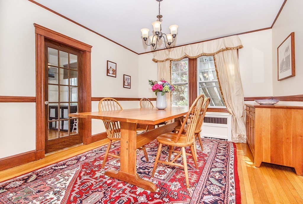 21 Watson Road, Unit 21 Belmont, MA 02478 - Photo 5 of 20 a view of a dining room with furniture wooden floor and a chandelier