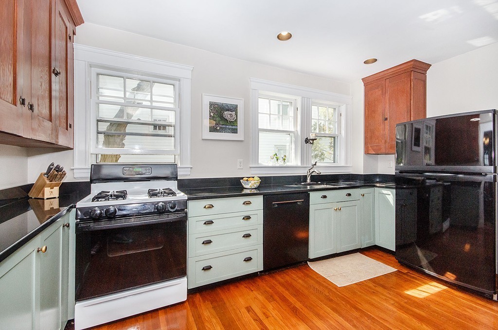 21 Watson Road, Unit 21 Belmont, MA 02478 - Photo 7 of 20 a kitchen with stainless steel appliances granite countertop a stove a sink and a microwave