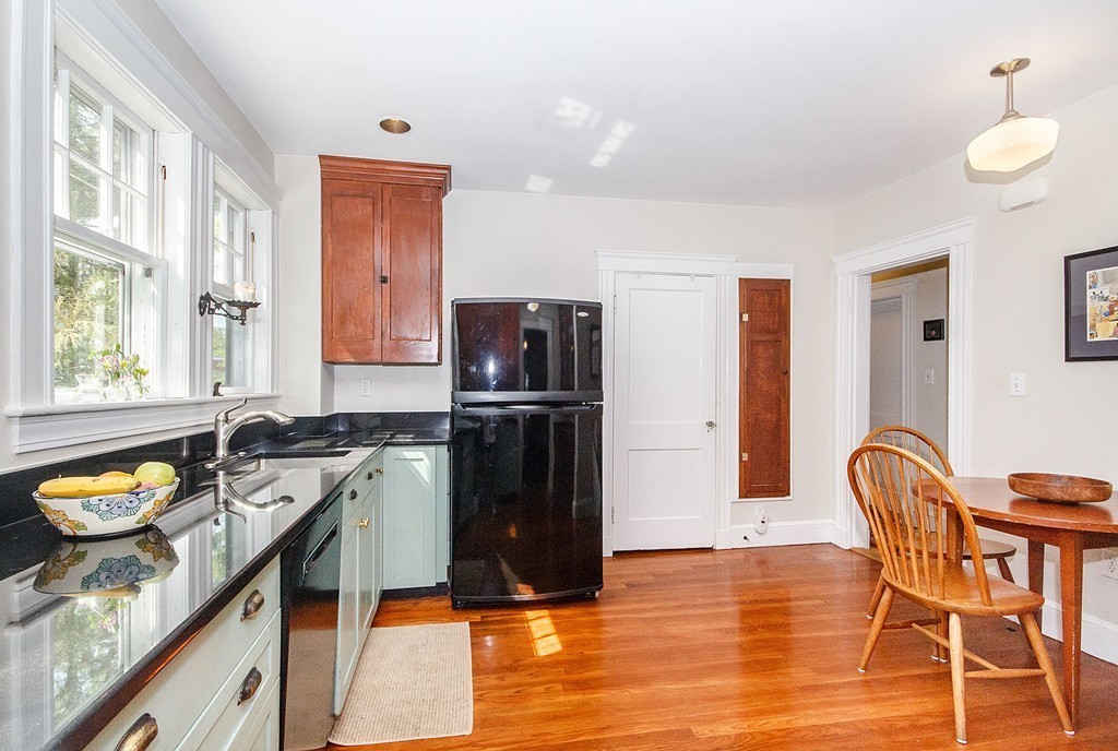 21 Watson Road, Unit 21 Belmont, MA 02478 - Photo 8 of 20 a kitchen with a refrigerator a stove a sink and a dining table with chairs