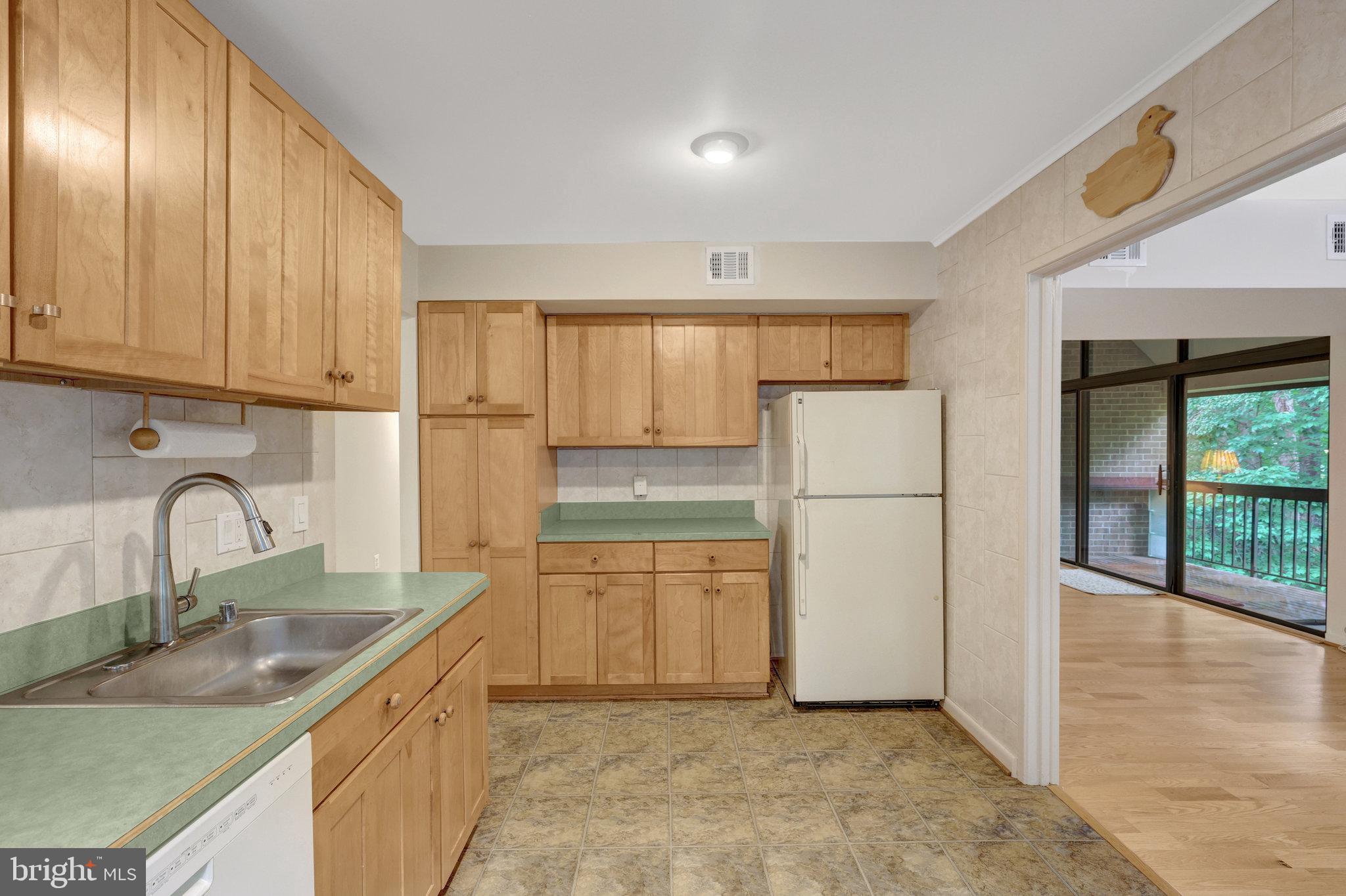 1665 Parkcrest Circle, Unit 301 Reston, VA 20190 - Photo 13 of 36 a kitchen with a refrigerator sink and cabinets