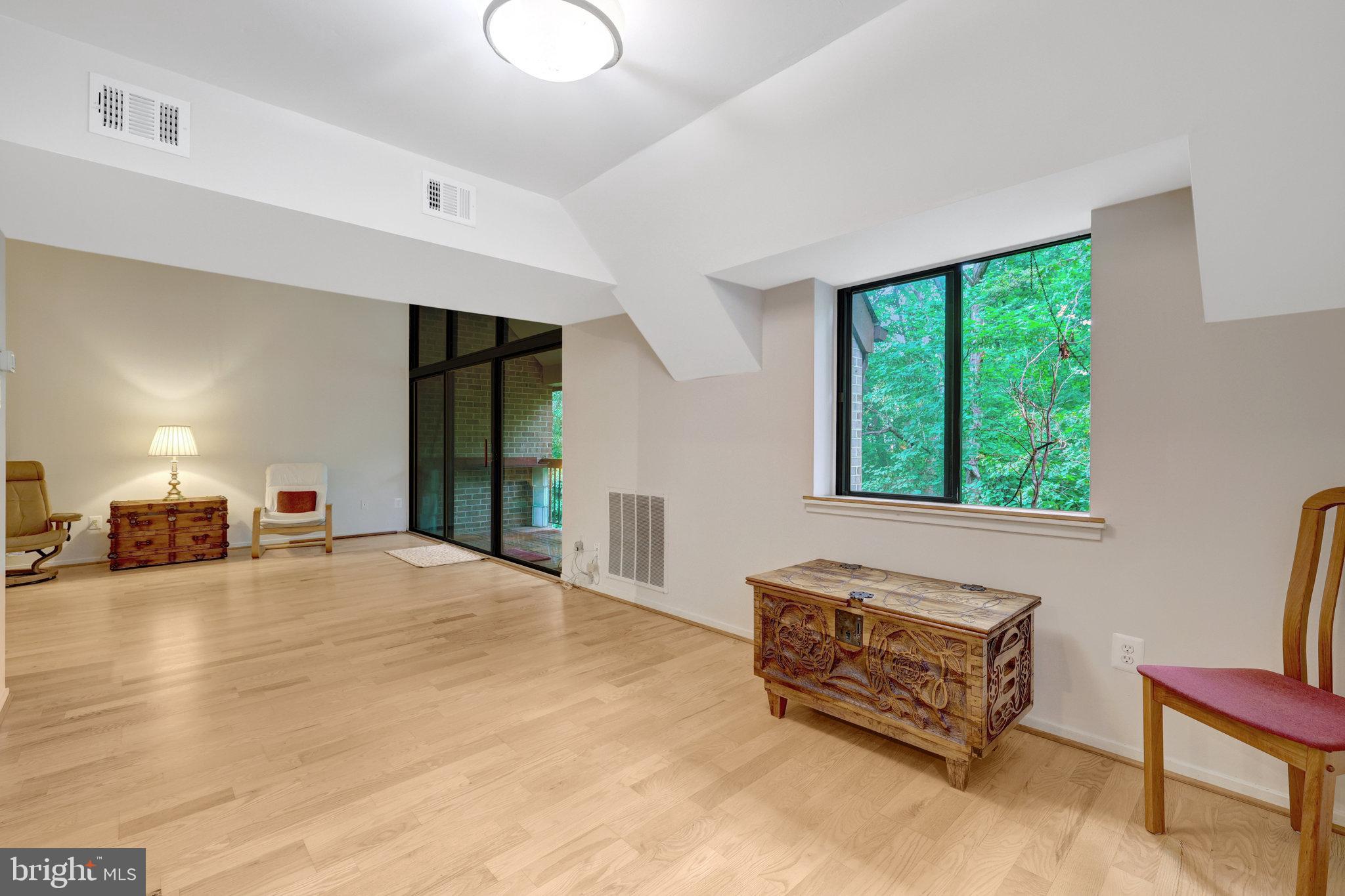 1665 Parkcrest Circle, Unit 301 Reston, VA 20190 - Photo 17 of 36 a spacious bedroom with a bed a table and a window