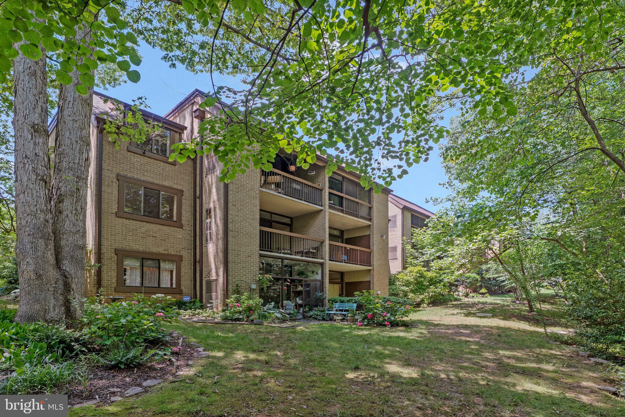 1665 Parkcrest Circle, Unit 301 Reston, VA 20190 - Photo 2 of 36 a brick building with a yard in front of it