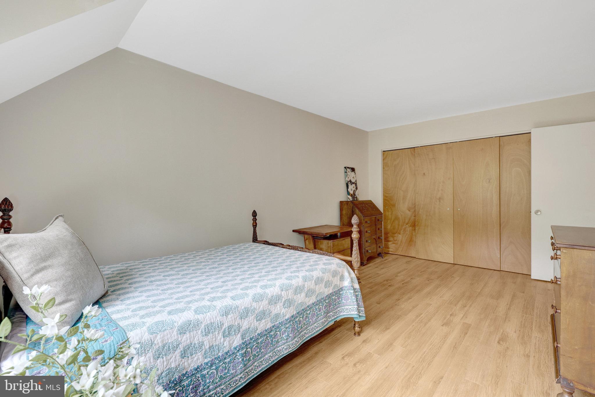 1665 Parkcrest Circle, Unit 301 Reston, VA 20190 - Photo 22 of 36 a bedroom with a bed and a table in it