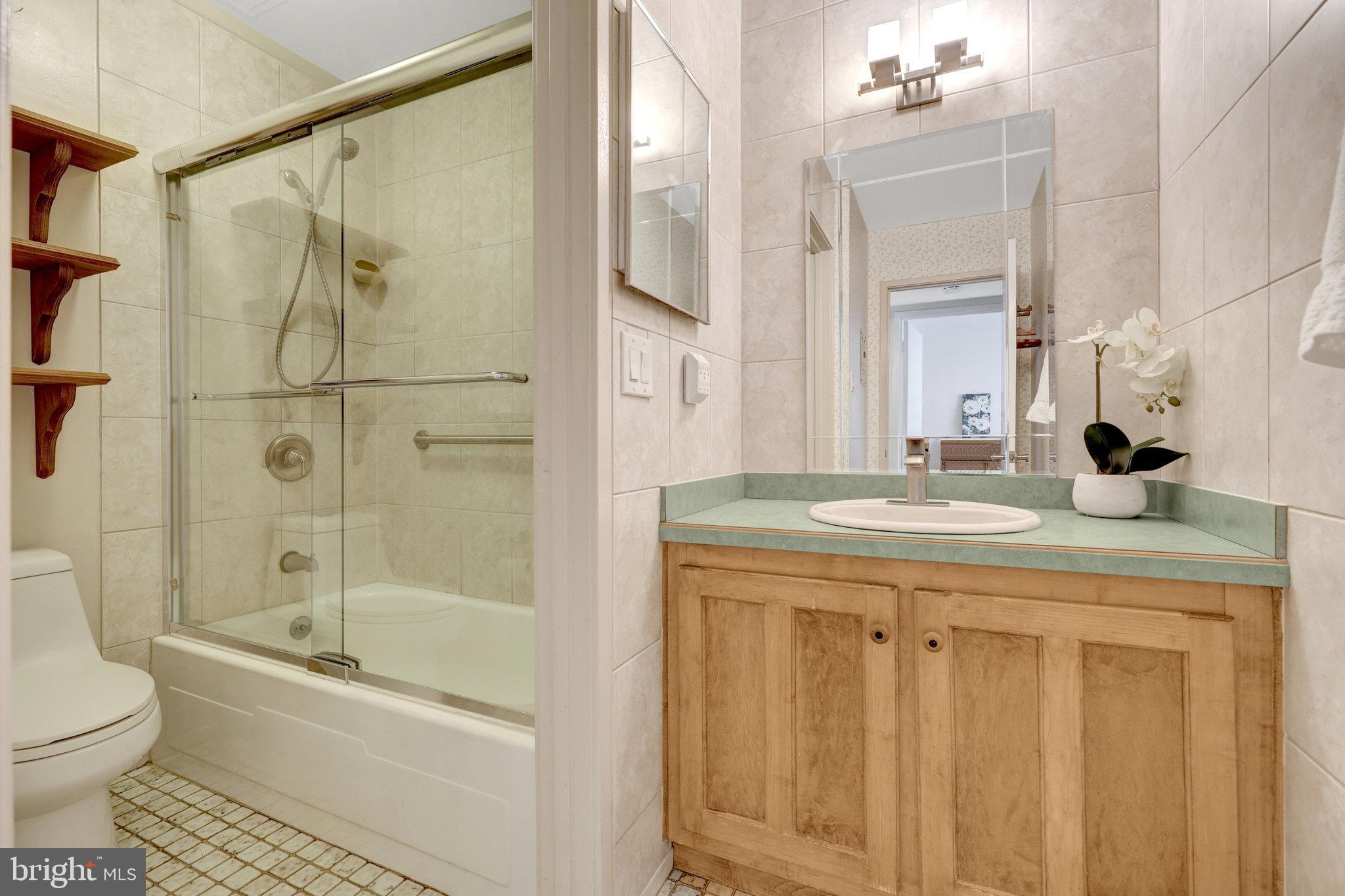 1665 Parkcrest Circle, Unit 301 Reston, VA 20190 - Photo 25 of 36 a bathroom with a granite countertop sink toilet and shower