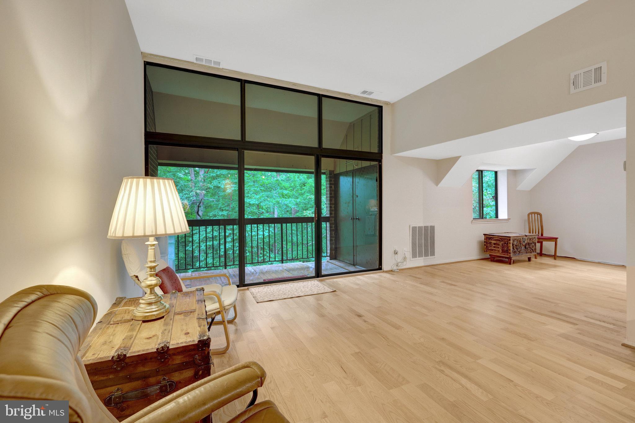 1665 Parkcrest Circle, Unit 301 Reston, VA 20190 - Photo 4 of 36 a bedroom with furniture and a large window