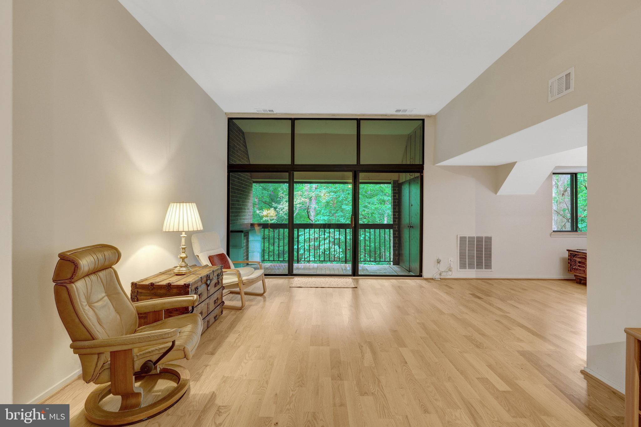 1665 Parkcrest Circle, Unit 301 Reston, VA 20190 - Photo 5 of 36 a living room with furniture and a large window