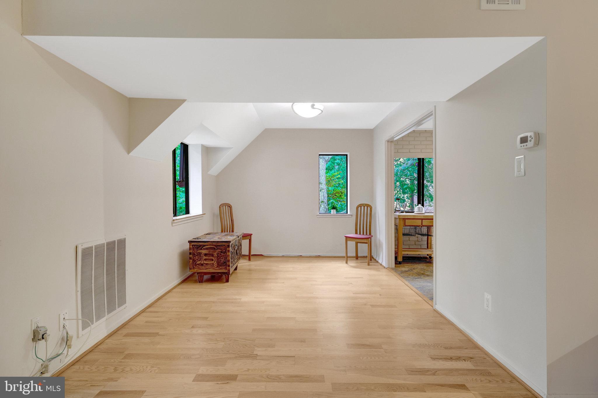 1665 Parkcrest Circle, Unit 301 Reston, VA 20190 - Photo 10 of 36 a bedroom with a bed and a chair