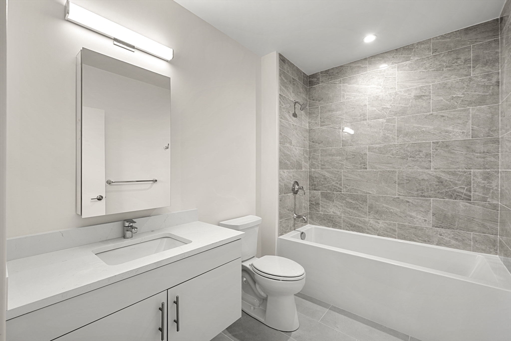 1151 Walnut Street, Unit 301 Newton, MA 02461 - Photo 5 of 14 a bathroom with a sink a toilet and shower