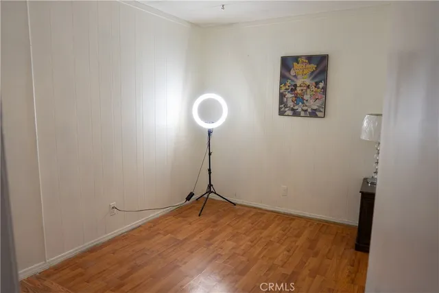 a view of a room with wooden floor and wall painting
