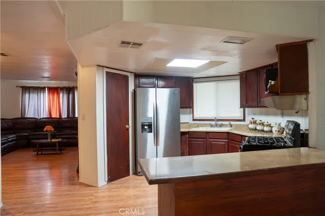 a kitchen with stainless steel appliances granite countertop a refrigerator and a stove top oven