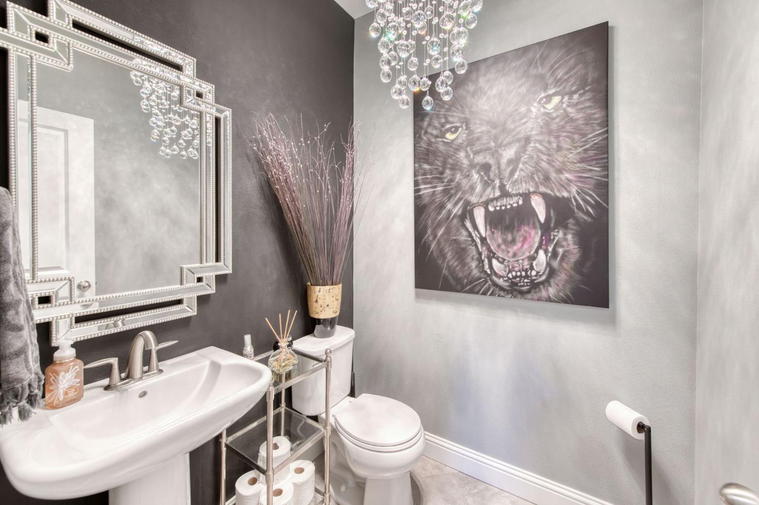 273 Meridian Avenue Madera, CA 93636 - Photo 12 of 55 a bathroom with a toilet sink and mirror