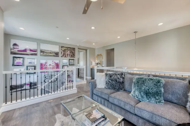 a bedroom with a bed wooden floor and window