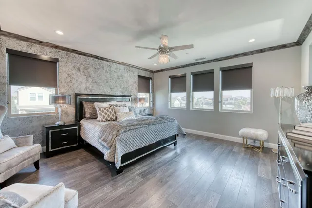 a bedroom with furniture and a flat screen tv