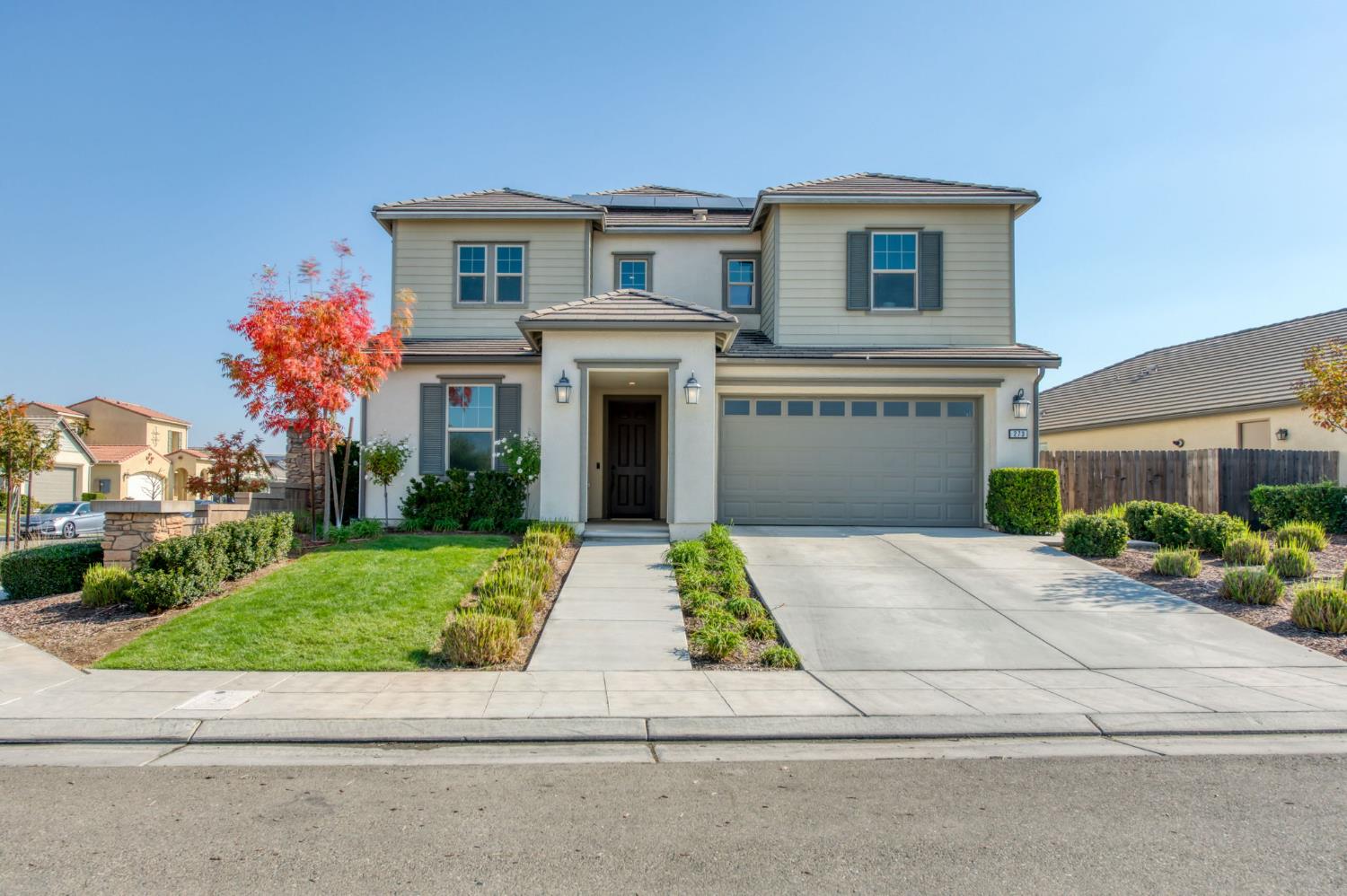 273 Meridian Avenue Madera, CA 93636 - Photo 2 of 55 a front view of a house with a yard and garage