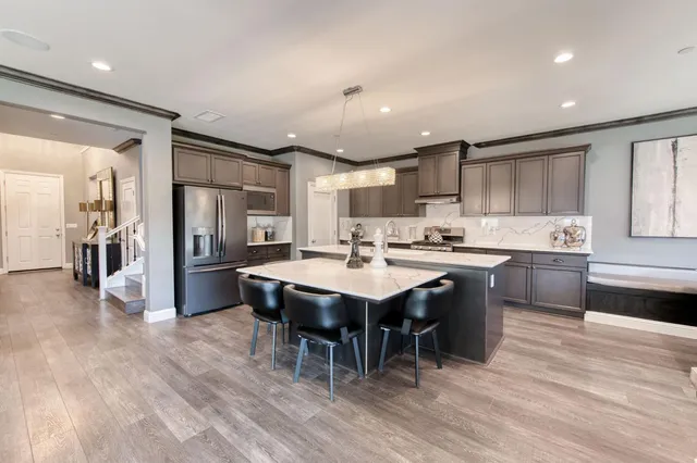 a kitchen with stainless steel appliances granite countertop sink stove and cabinets