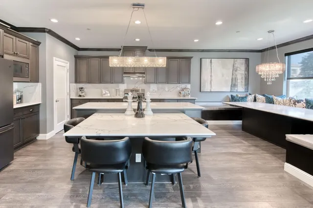 a view of a dining room with a table chairs and chandelier